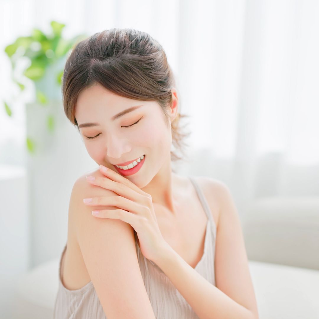 a woman touching her skin happily
