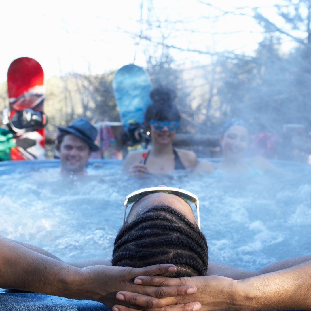 people relaxing in a hot tub in the winter