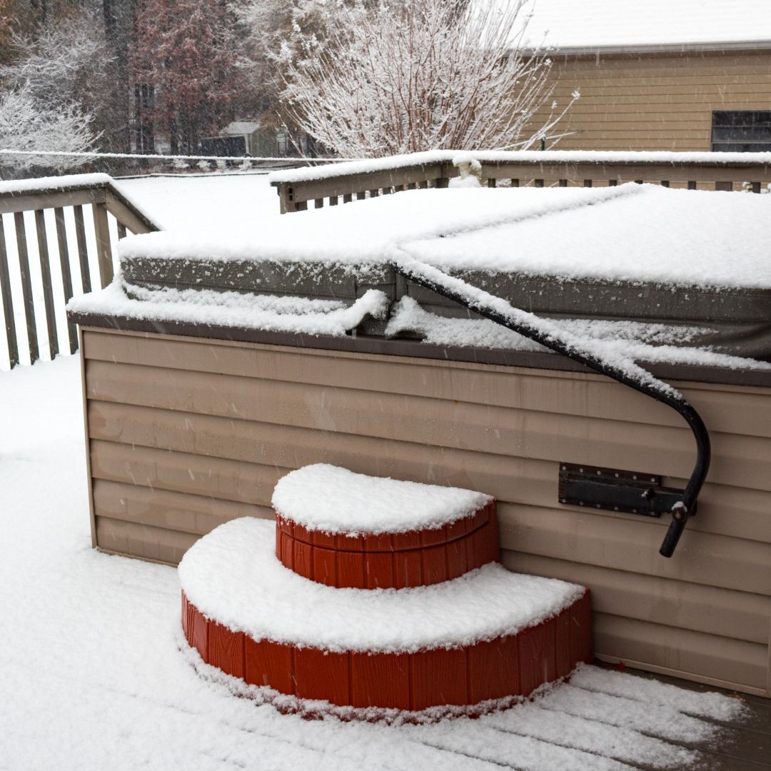 a hot tub closed on a deck in winter